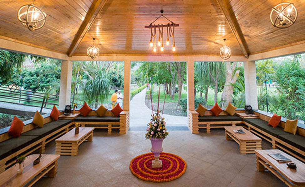 Here the view of sitting area of Tarangi Resort, A luxury by riverside resort in corbett