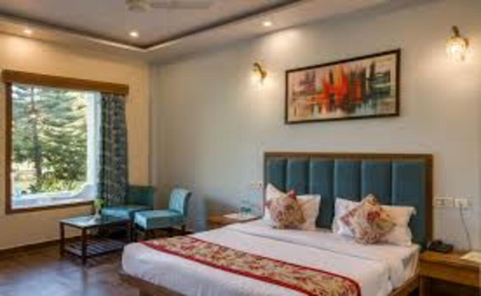 View of superior room with bed and side window